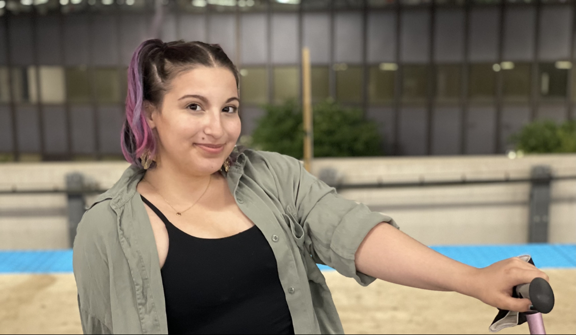 Girl sitting on bench with cane.